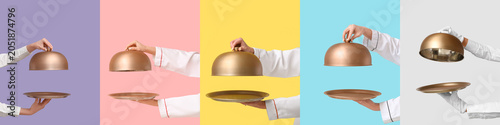 Cuadro en lienzo Professional chef hands holding golden cloche and serving tray on colorful backg