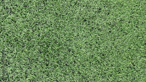 High angle close up of seamless green artificial grass turf background texture