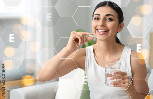 Young woman with vitamin E ...