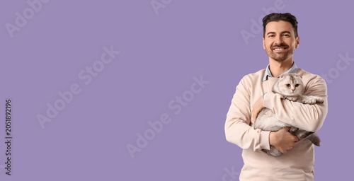 Smiling man cuddling adorab...