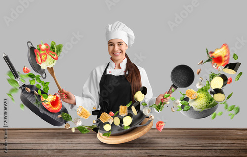 Young female chef with sauc...
