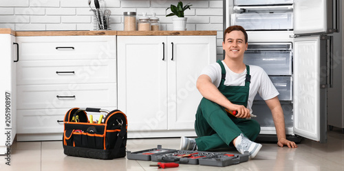 Happy male worker of repair...