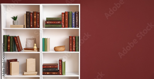 Big bookshelf near burgundy...