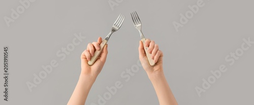 Two hands holding forks wit...