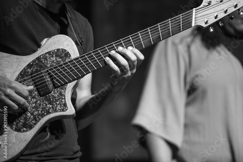 Photography Monochrome jazz guitarist with blurred musician in background