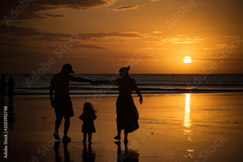 Family silhouettes on Jericoacoara beach at sunset
