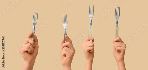 Four hands holding up diffe...