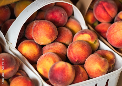 fresh peaches in a basket in a farmers market
