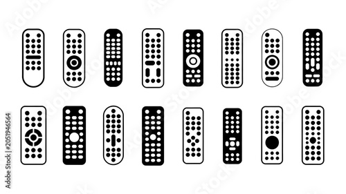 A collection of remote controls on a plain surface with various designs