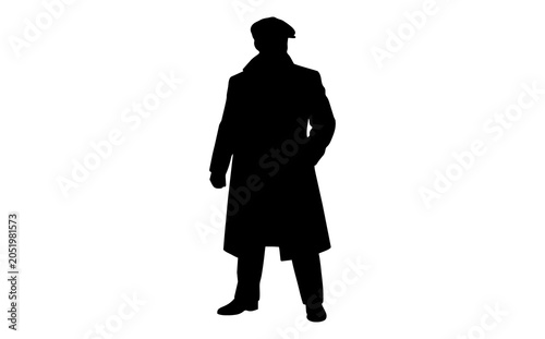 Silhouette of a stylish man wearing a long coat and hat standing confidently against a plain white background emphasizing fashion elegance