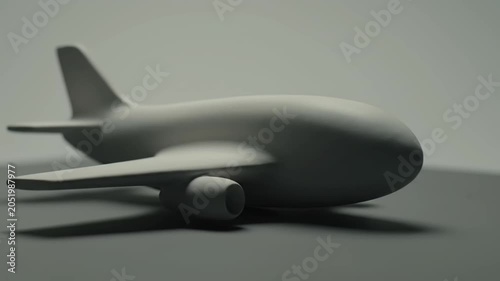 Minimalist Gray Airplane Model Isolated on a Smooth Surface.