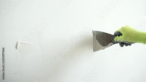 Worker Applies Wall Putty With A Spatula For Wall Preparation Before Painting