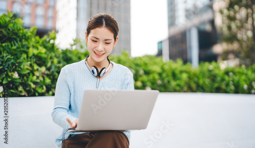 Принти на полотні Beautiful young adult business asian woman hand typing keyboard looking at lapto