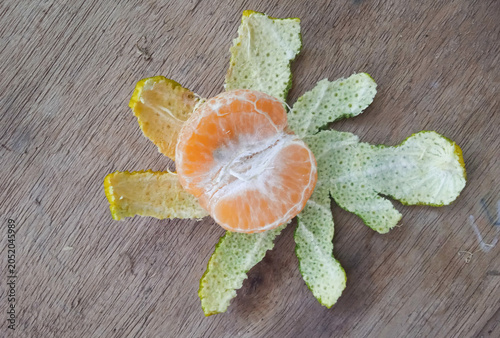 peeled orange isolated on a wooden board 