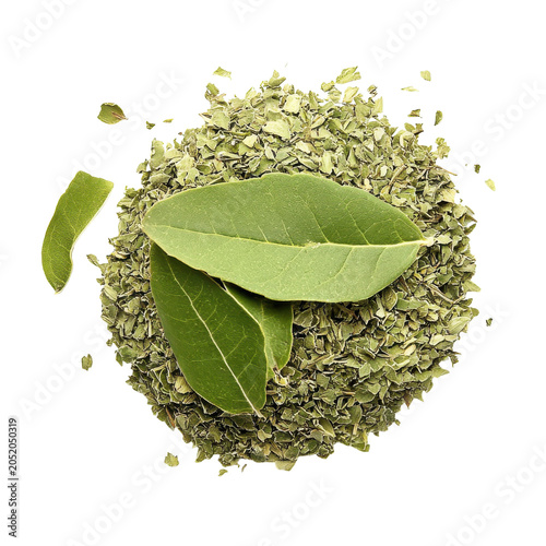 Freshly crushed bay leaves and dried crumbles isolated on white background