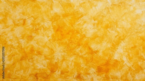 Abstract golden yellow wall texture with artistic paint brush strokes for artistic decorative background design projects.