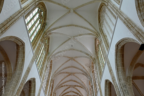 Bild auf Leinwand Low-angle symmetrical interior shot looking up at the medieval Gothic ribbed vaulted stone ceiling and upper arched windows of Lala Mustafa Pasha Mosque, formerly St