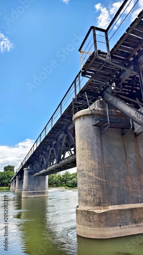 The Yongding River and the Sanjiadian Railway Bridge under a blue sky and white clouds in Mentougou District, Beijing, China