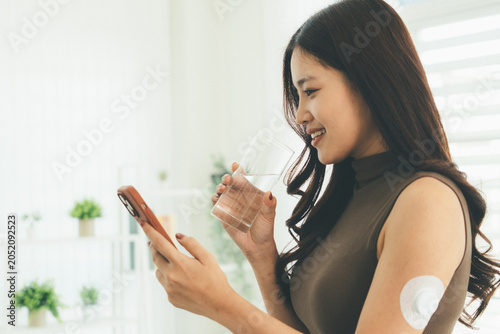 Woman Checking Blood Glucose Level During Telehealth Consultation at Home