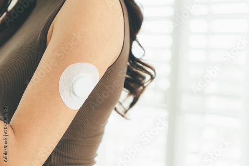 Woman Checking Blood Glucose Level During Telehealth Consultation at Home