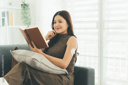 Woman Checking Blood Glucose Level During Telehealth Consultation at Home