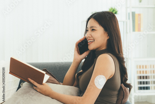 Woman Checking Blood Glucose Level During Telehealth Consultation at Home
