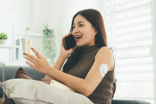 Woman Checking Blood Glucose Level During Telehealth Consultation at Home