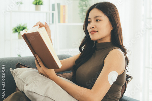 Woman Checking Blood Glucose Level During Telehealth Consultation at Home