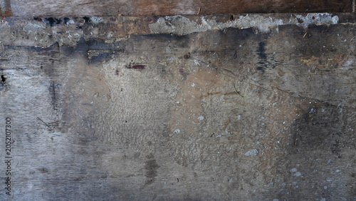Close-up detail of a cement wall texture with dirt stains, rough surface patterns, and weathered marks. Ideal for grunge backgrounds, construction themes, abstract textures, and graphic design resourc