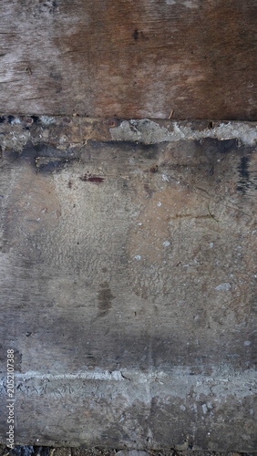 Close-up detail of a cement wall texture with dirt stains, rough surface patterns, and weathered marks. Ideal for grunge backgrounds, construction themes, abstract textures, and graphic design resourc
