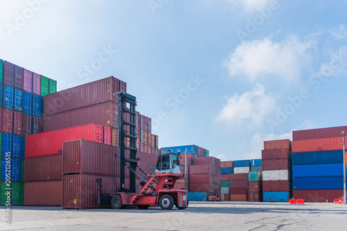 Принти на полотні Heavy duty forklift lifting containers at global logistics distribution yard, In