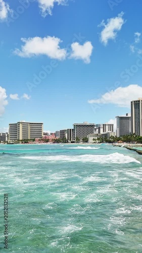 Vertical shot of luxury beachfront hotels along the shore of Waikiki