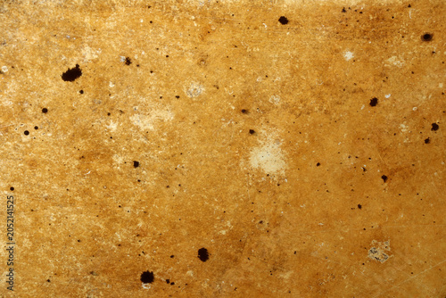 Foto Close view of a textured surface showing brown tones and various spots in a warm