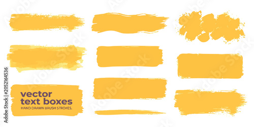 Set of yellow hand drawn brush stroke shapes and abstract paint texture elements for creative design work