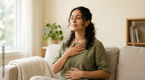 Woman practicing breathwork with hand on chest, mindful breathing and stress management concept