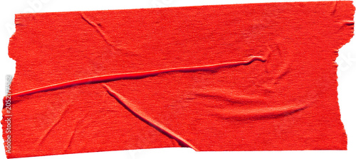 Fotografie Red adhesive masking tape strip with creases isolated on dark background