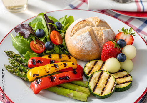 Grilled vegetables and fresh fruits served on a plate with bread outdoors on a table.