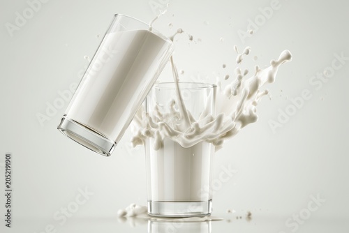 Milk splashing between two glasses in a bright studio setting with sharp focus for dairy product advertising