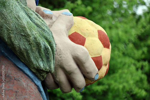 Fotografija Close-up of a kashubian troll statue's hand holding a red and yellow ball