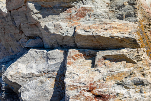 Close-up of a rocky cliff with natural textures and colors.