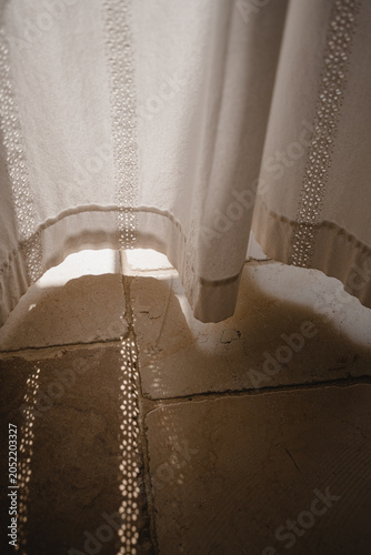 Detailed View Of Delicate Cotton Textile With Intricate Embroidery Patterns And Soft Shadows On Natural Stone