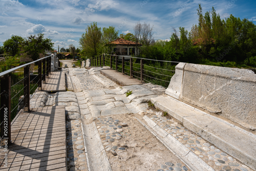 Fototapeta premium Detailed view of the historic Roman Bridge in Aizanoi Ancient City, showcasing ancient stone pavement and Roman engineering
