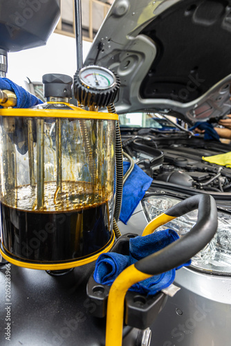 Auto mechanic working in repair shop garage. Vehicle maintenance and inspection service