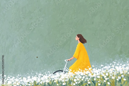 A woman in a yellow dress riding a bicycle through a field of daisies with a wall in the background.