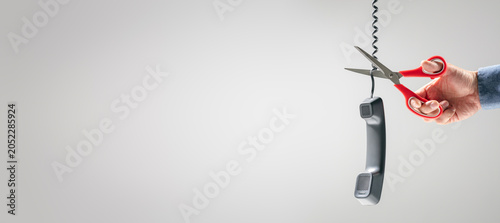 Photos Scissors cutting telephone line connection to end call or terminate phone contra