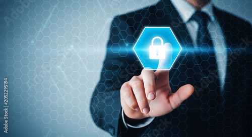 Man in suit touching glowing blue hexagon with white padlock icon hand finger