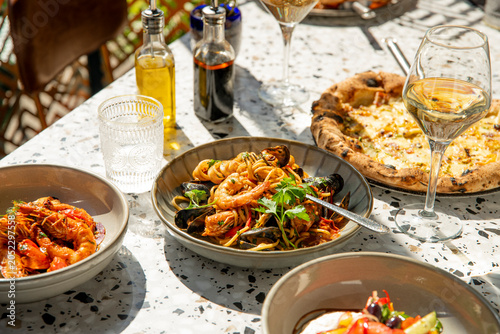 Cuadro en lienzo Dining Al Fresco With a Seafood Feast, Delicious Pasta, and Gourmet Pizza Under