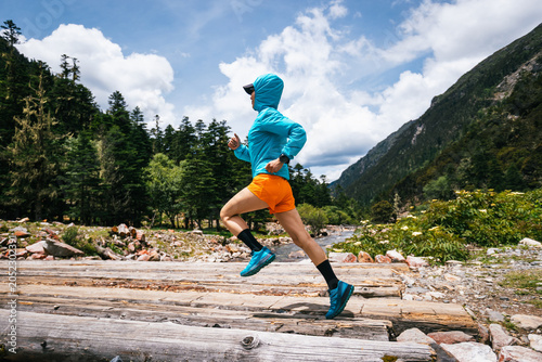 Konstfotografi Woman trail runner cross country running in high altitude mountains