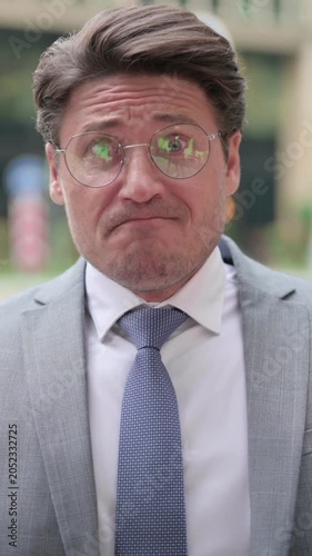 Upset Middle Aged Businessman Reacting to Failure, Outdoor, vertical video