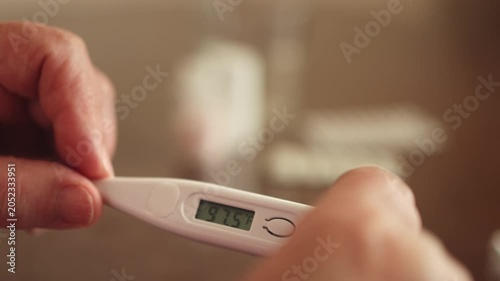 Thermometer. Thermometer. Hands. Body temperature. Slow motion video.. High quality 4k footage